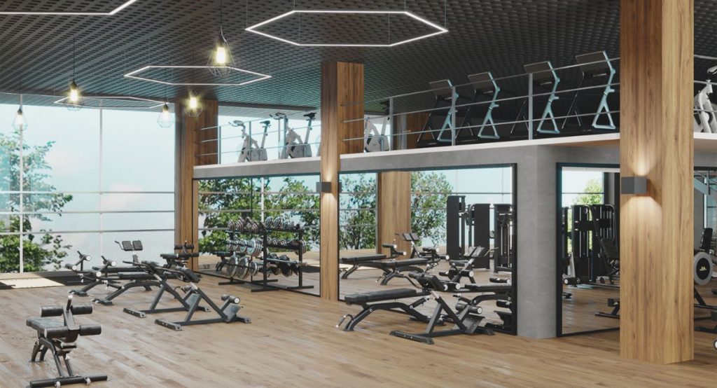 Interieur d une salle de fitness moderne avec equipements sur parquet bois